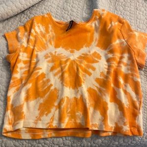The color of this crop top is orange and white.